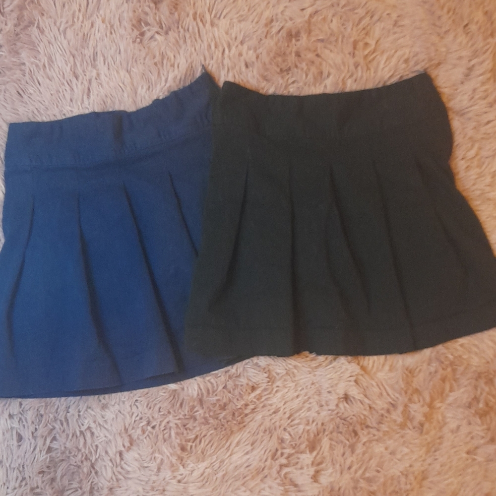 Children place blue and khaki uniform skorts